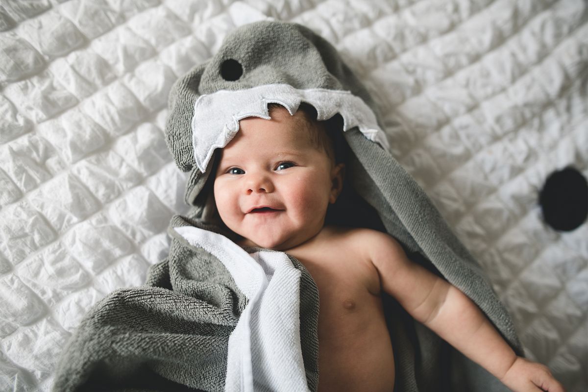 baby wearing shark hooded bath towel