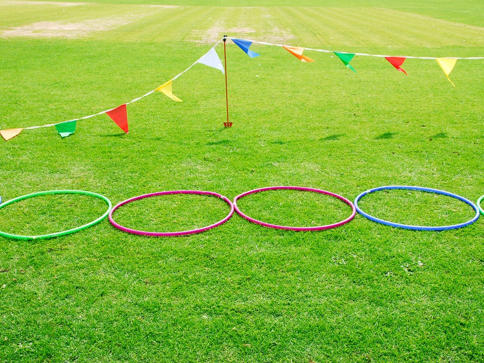 three hula hoops set up in the grass as an obstacle course, a good housekeeping pick for best camping activity