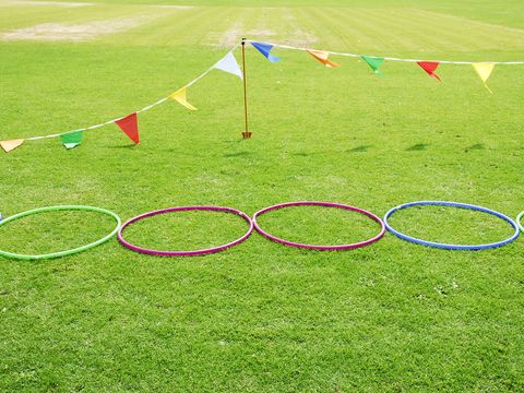 three hula hoops set up in the grass as an obstacle course, a good housekeeping pick for best camping activity