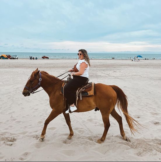 woman riding a horse on the beach on south padre island