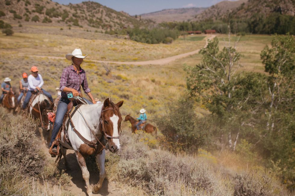 Trail riding, Horse, Pack animal, Wrangler, Rein, Outdoor recreation, Western riding, Animal sports, Ranch, Recreation, 