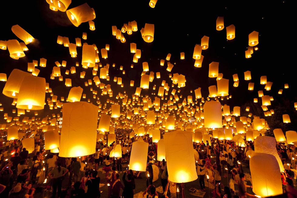 a sky full of lanterns celebrating the end of the lunar new year