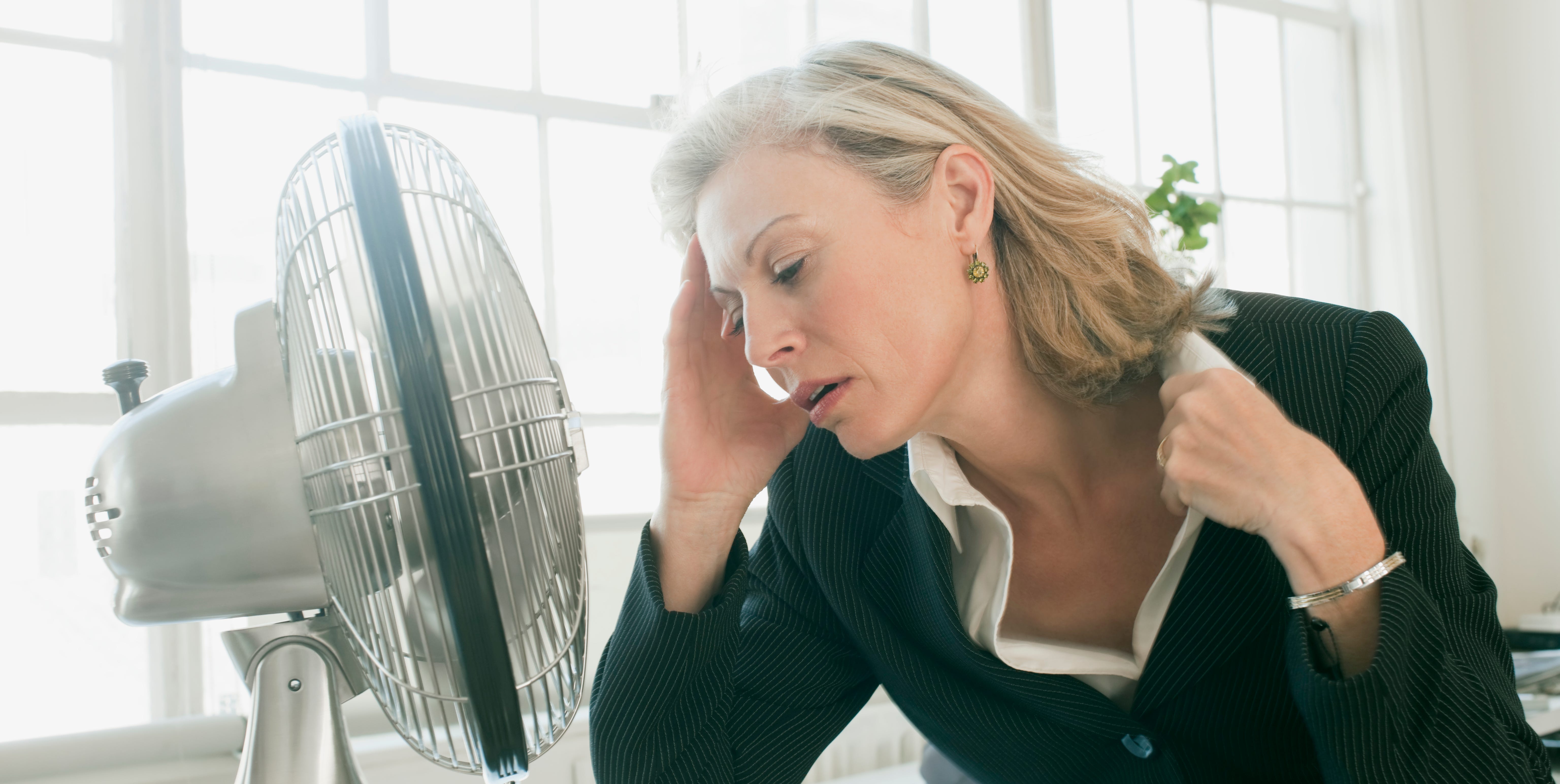 hot businesswoman sitting in front of fan