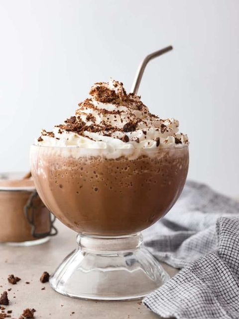 frozen hot chocolate in large glass cup with straw