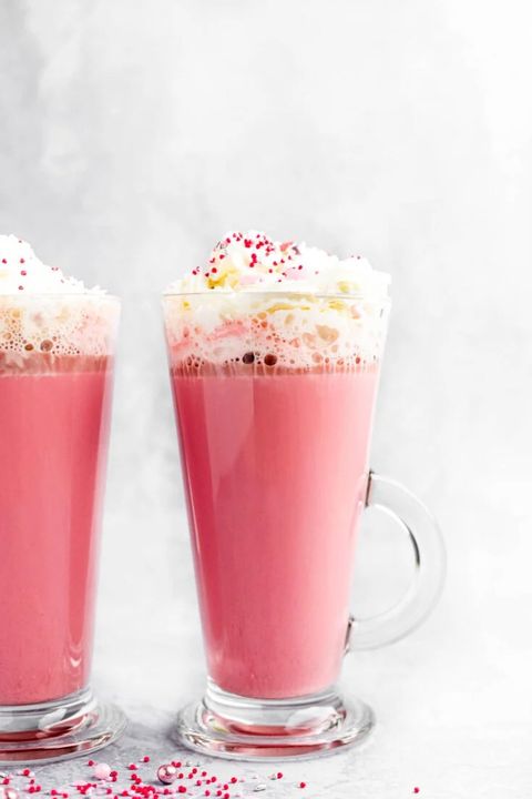 red velvet hot chocolate with whipped cream and red and pink sprinkles