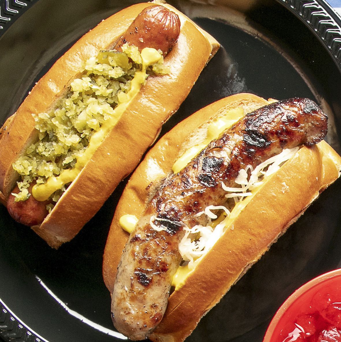 https://hips.hearstapps.com/hmg-prod/images/hot-dogs-bratwurst-sauerkraut-relish-1617121927.jpg?crop=0.737xw:0.740xh;0.167xw,0.0498xh&resize=1200:*