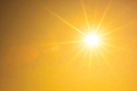 hot summer or heat wave background, orange sky with glowing sun