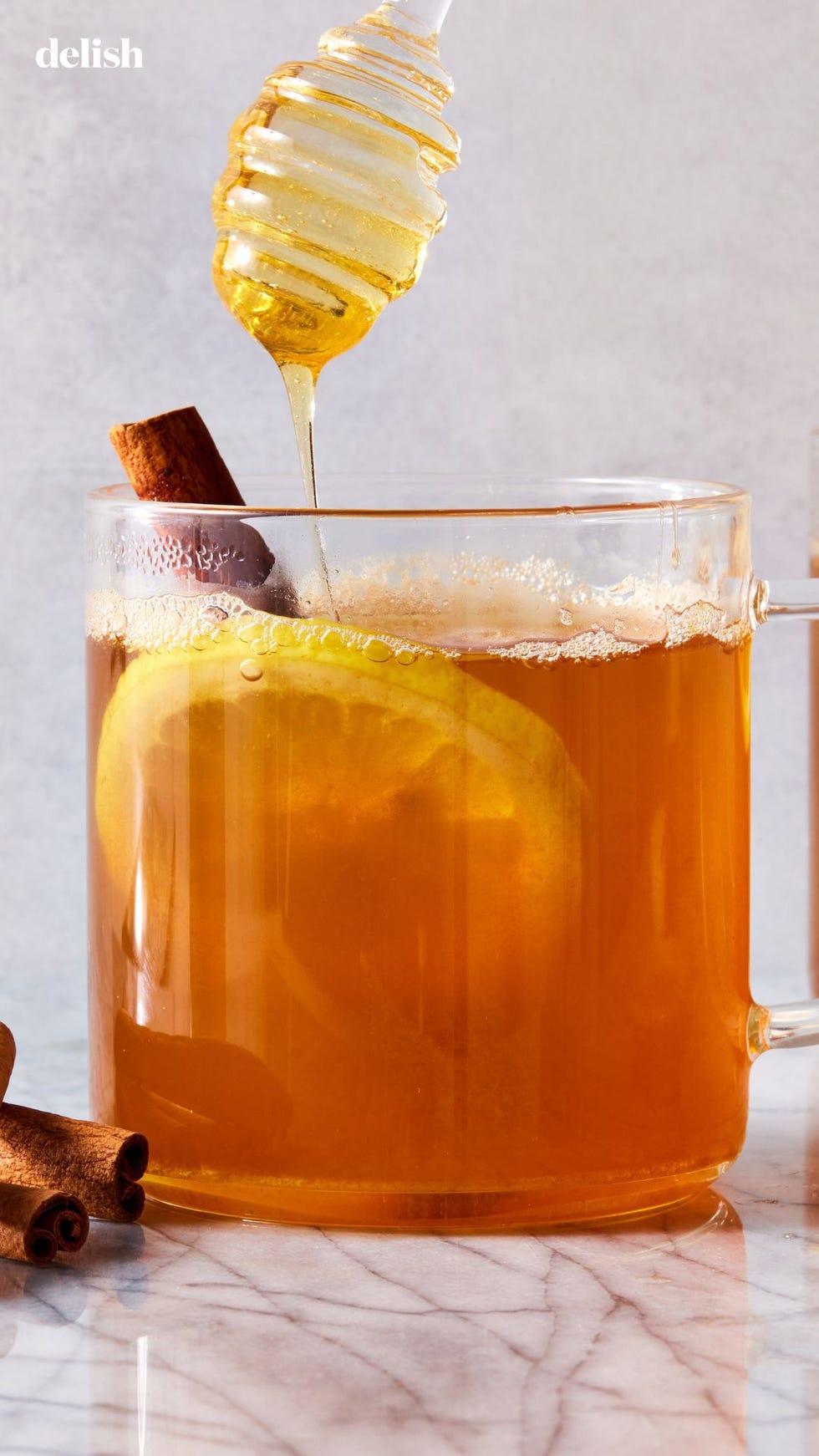 a glass of liquid with a spoon