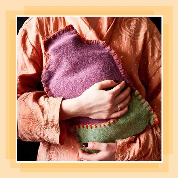 a person holding a hot water bottle