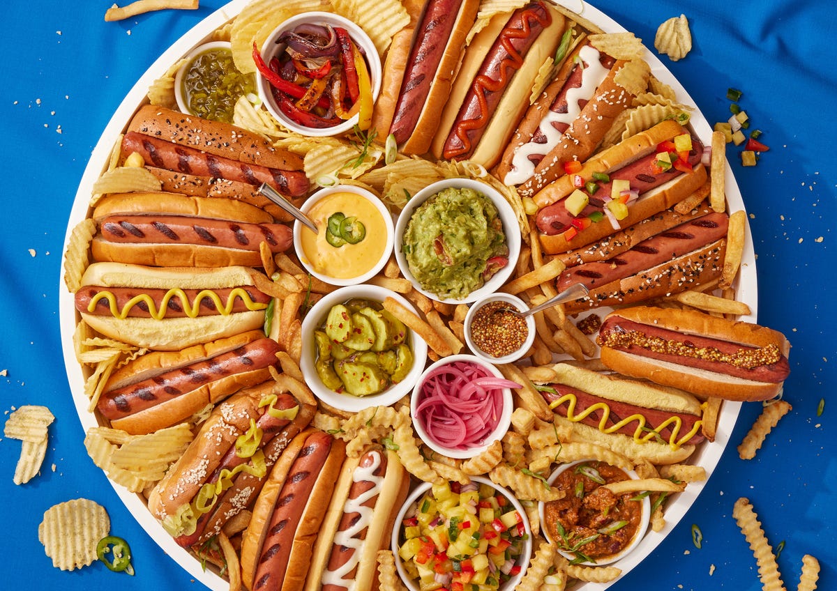 tray full of hot dogs with fun toppings