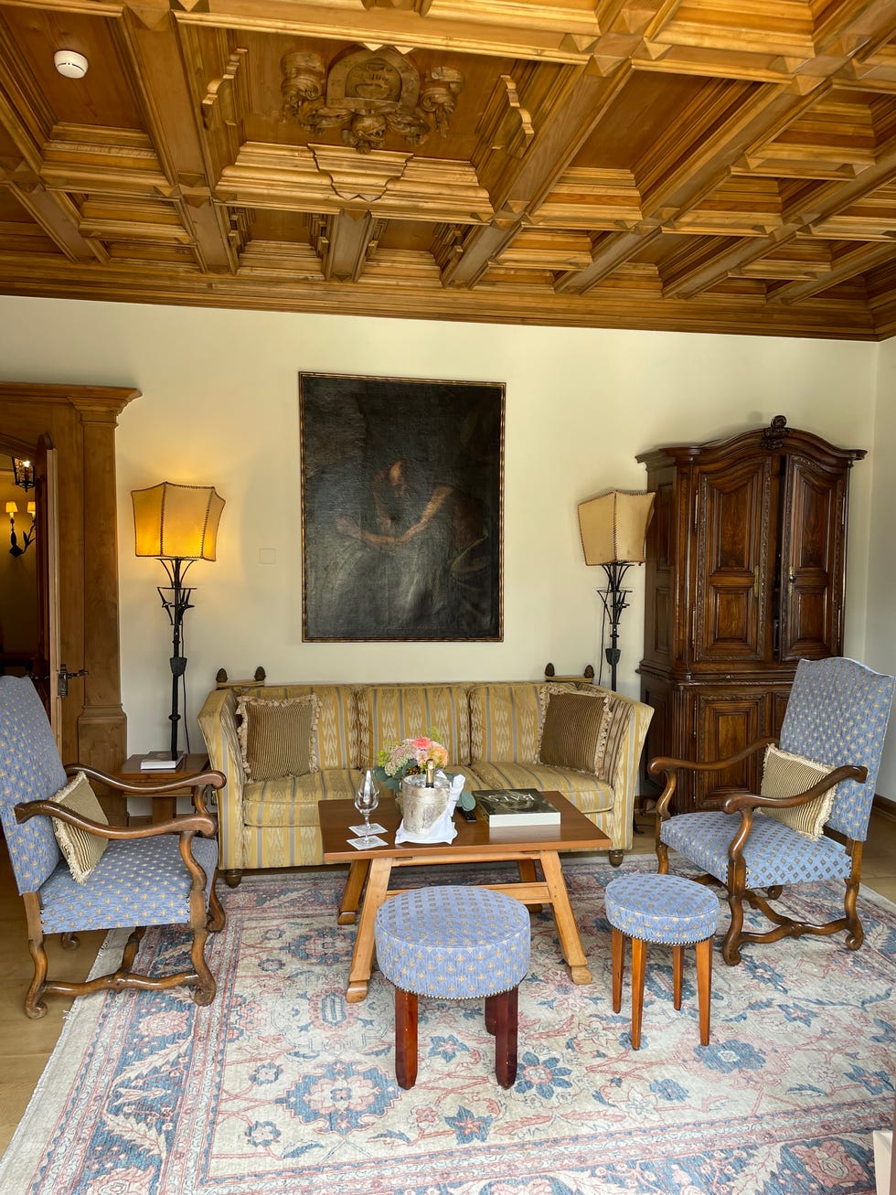 the hitchcock suite living room features an intricate woodpaneled ceiling