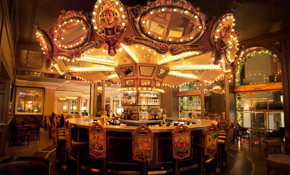 a large room with a bar and chandeliers