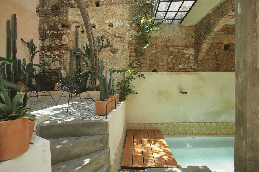 Fixie Lofts boutique hotel in Santo Domingo with exposed stone walls and a pool in the interior patio