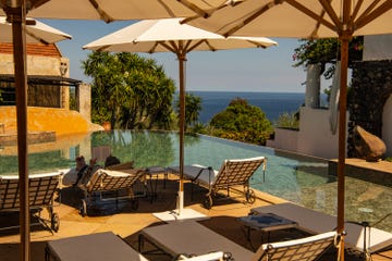 a pool with chairs and umbrellas