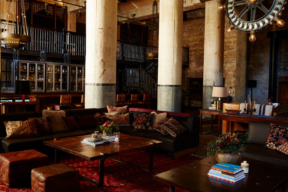 a large room with a large chandelier and a couch