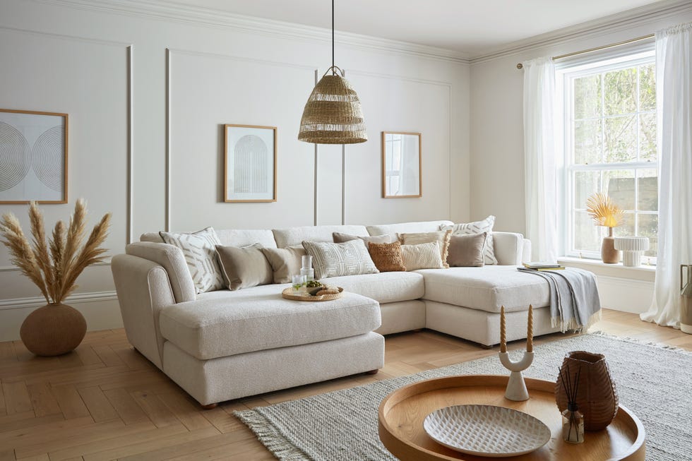 a living room with a white U-shaped sofa