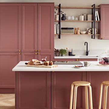 a kitchen with a pink cabinet