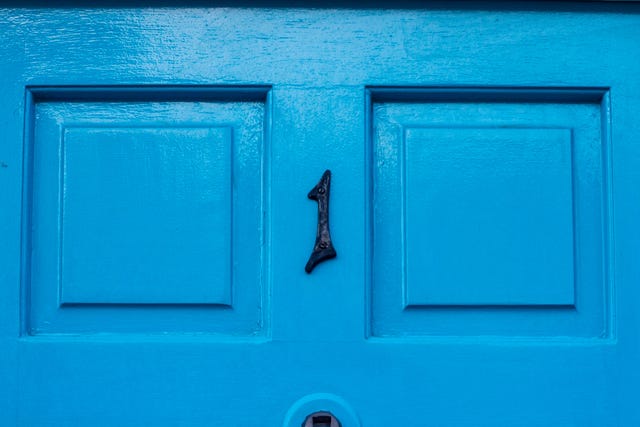 house number 1 on a blue wooden front door in london