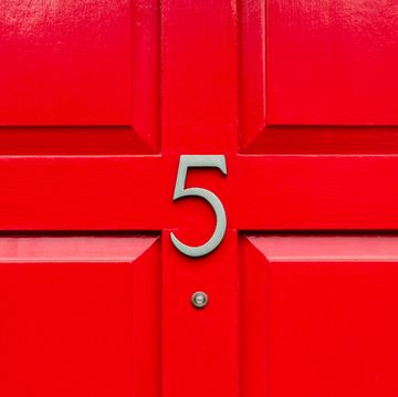 house number 5 on a red wooden front door in london