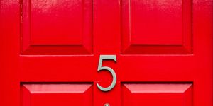 house number 5 on a red wooden front door in london