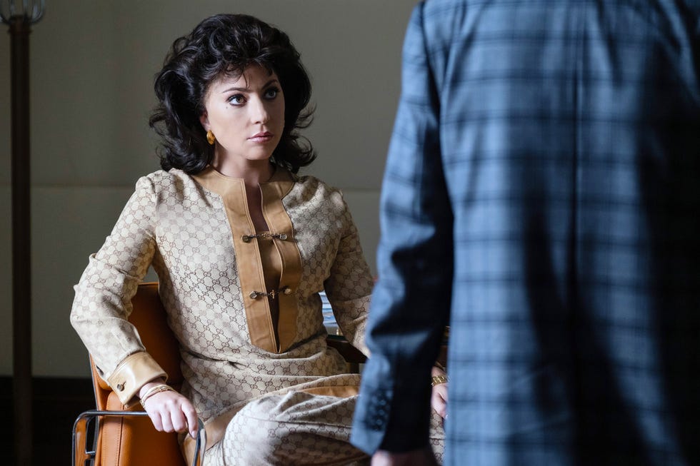 a brunette woman sitting on a chair