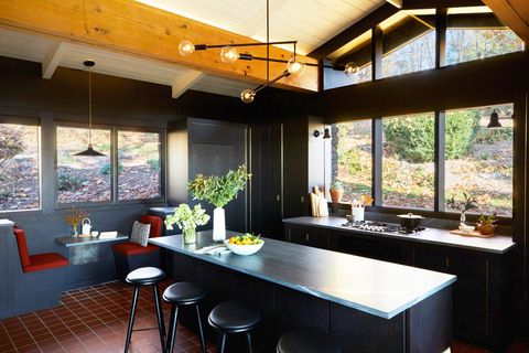 midcentury modern kitchen with black paint and banquette