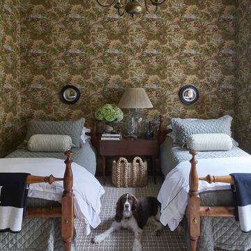 belgian flax linen quilts cover a pair of twin beds that both sam and his father slept in as children and the small convex mirrors are by oka and the check rug is by fibreworks