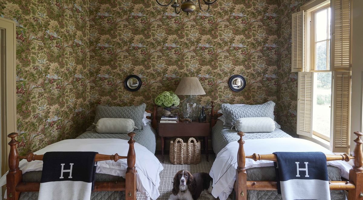 belgian flax linen quilts cover a pair of twin beds that both sam and his father slept in as children and the small convex mirrors are by oka and the check rug is by fibreworks