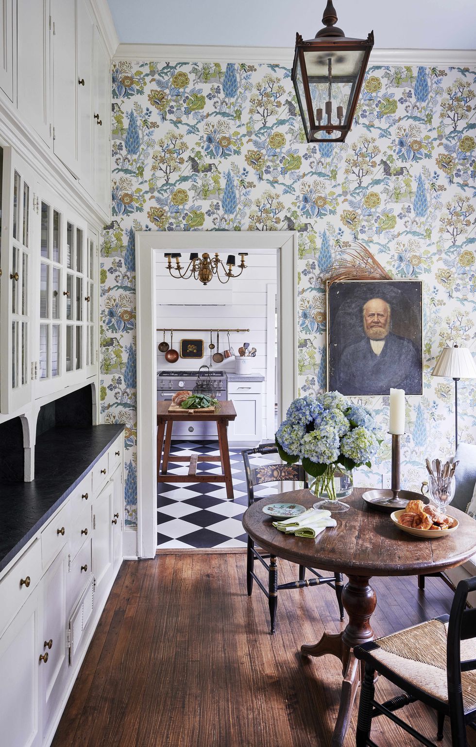 for the breakfast room and kitchen an animated wall pattern first developed in the early 20th century with graphic black and white flooring true to american farmhouse vernacular