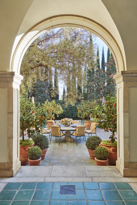 a poolside dining terrace, alive with potted kumquats and mandarins
