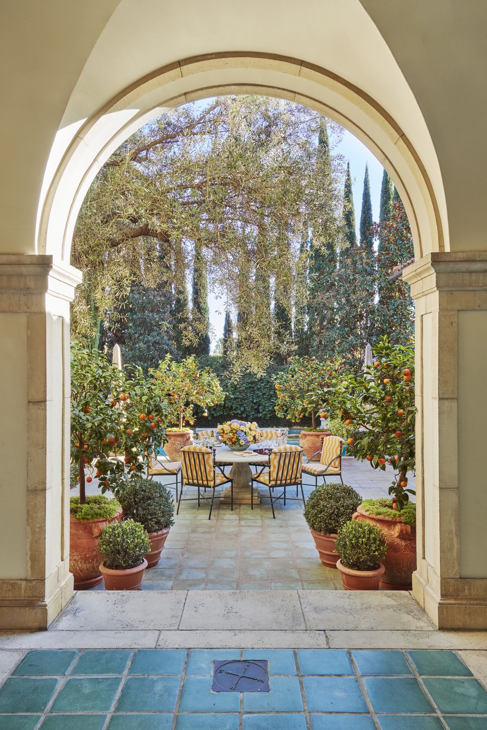 a poolside dining terrace, alive with potted kumquats and mandarins