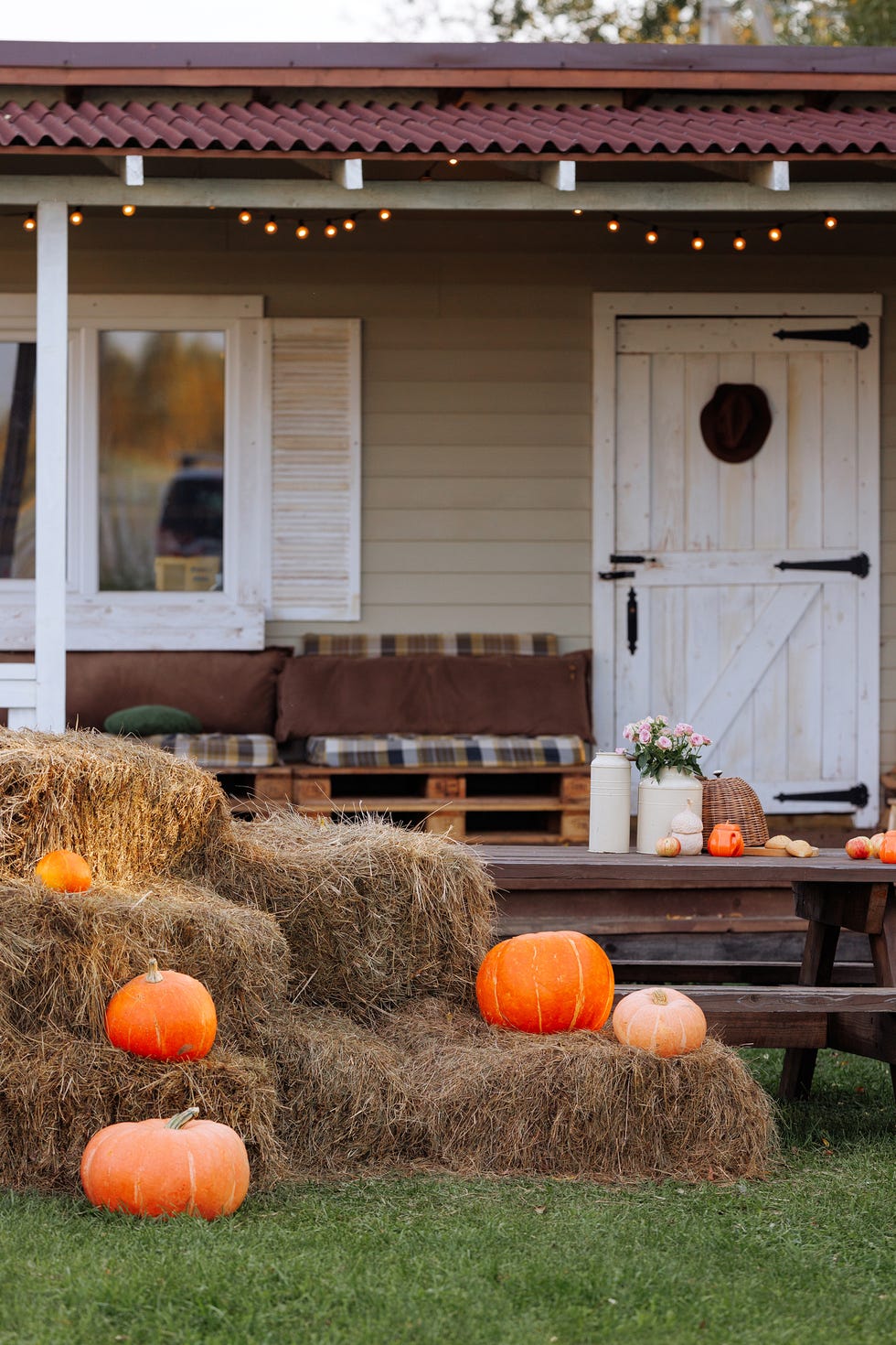 house yard decorated with pumpkins and hay bales for halloween