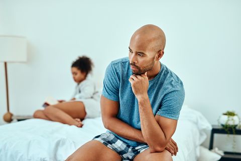 couple having a tense moment in bed