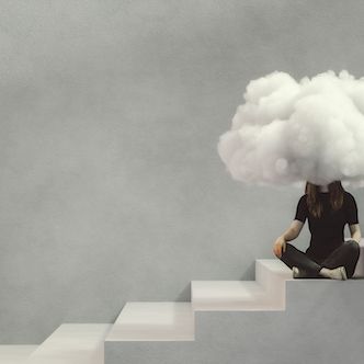 teenage woman sitting on the concrete stairs with a cloud covering her face