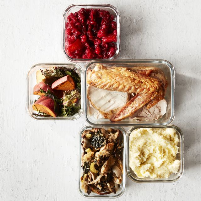 cranberry sauce, stuffing, mashed potatoes, turkey, greens and yams in leftover containers overhead
