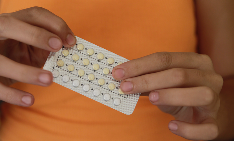 a person holding the contraceptive pill