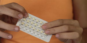 a person holding the contraceptive pill