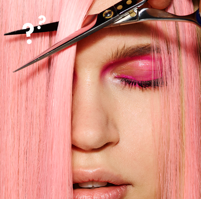 how often should you cut your hair   image of woman with pink hair trimming her hair with scissors