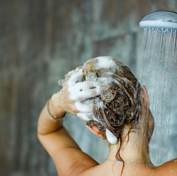 woman washing her hair with shampoo
