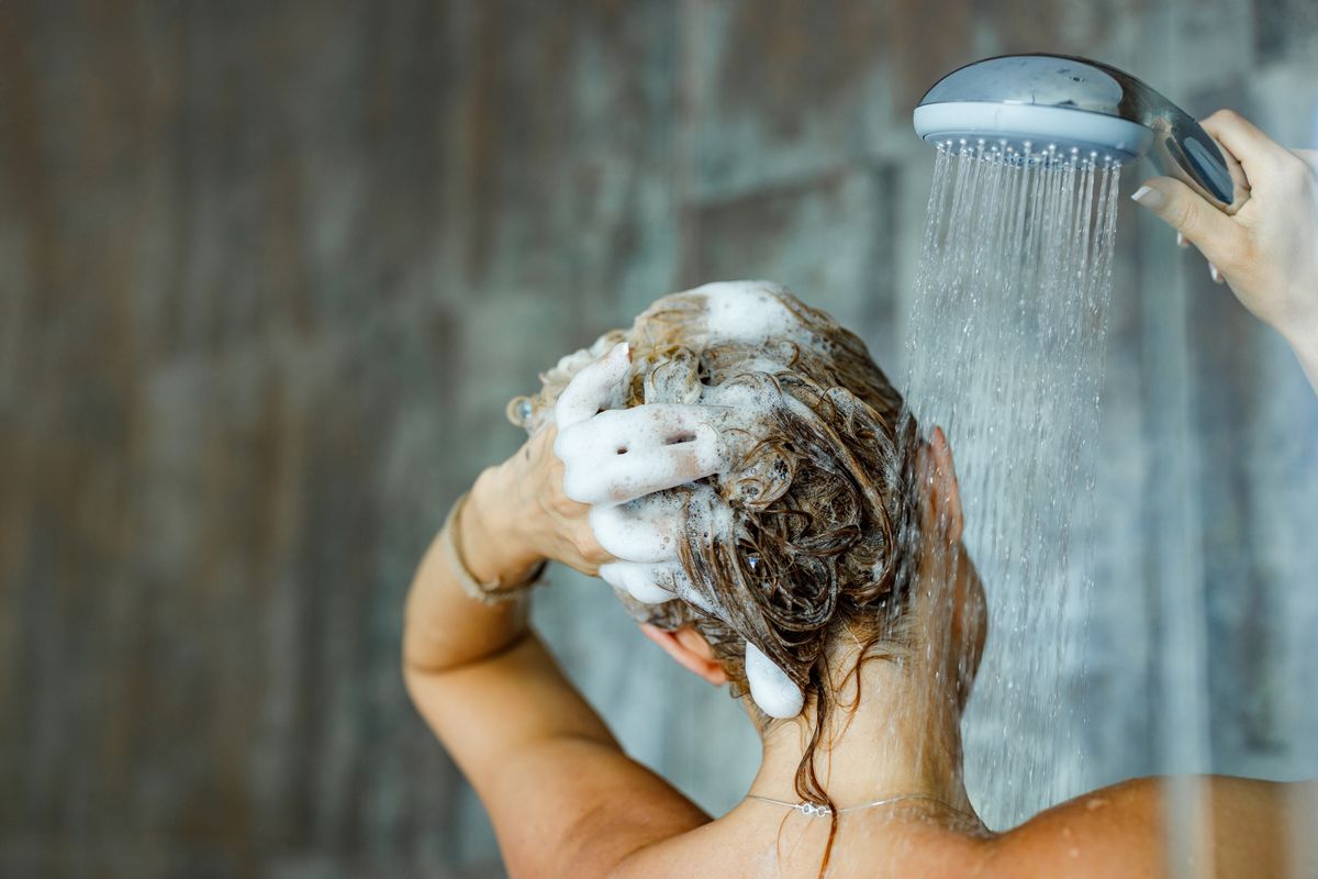 woman washing her hair with shampoo
