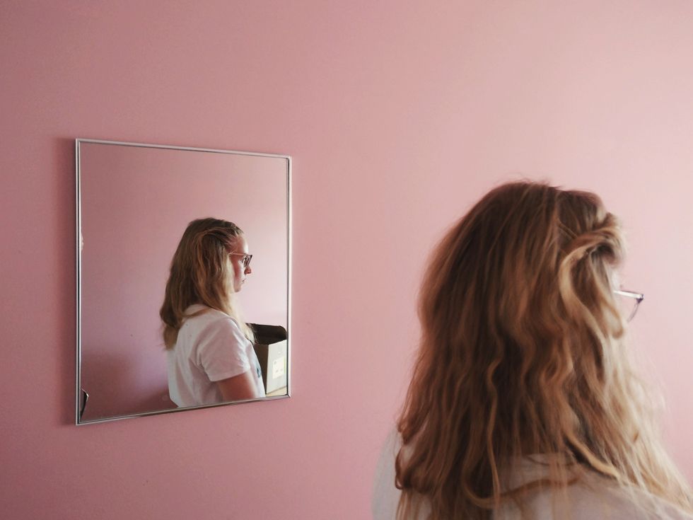 woman next to a mirror