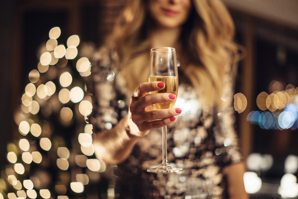 woman hold prosecco at christmas party