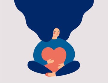 young woman embraces a big red heart