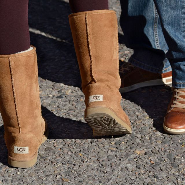 how to clean uggs, a woman wears a pair of ugg boots
