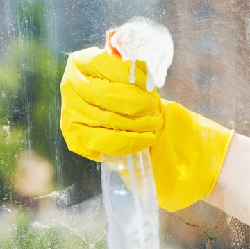 how to clean windows how to clean windows, hand in rubber glove washes home window from spray bottle