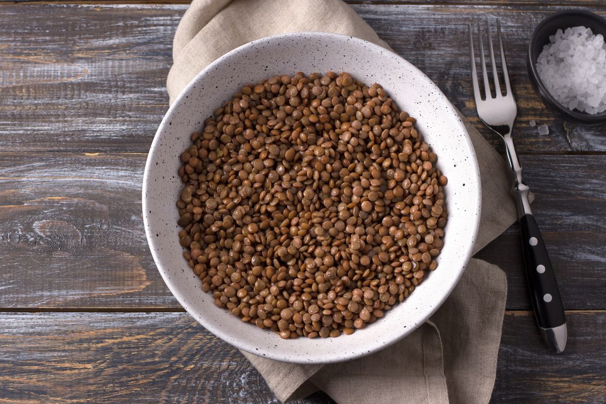 bowl of lentils on wood with napkin
