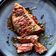 steak with herbs on a blue plate, how to cook steak in the oven