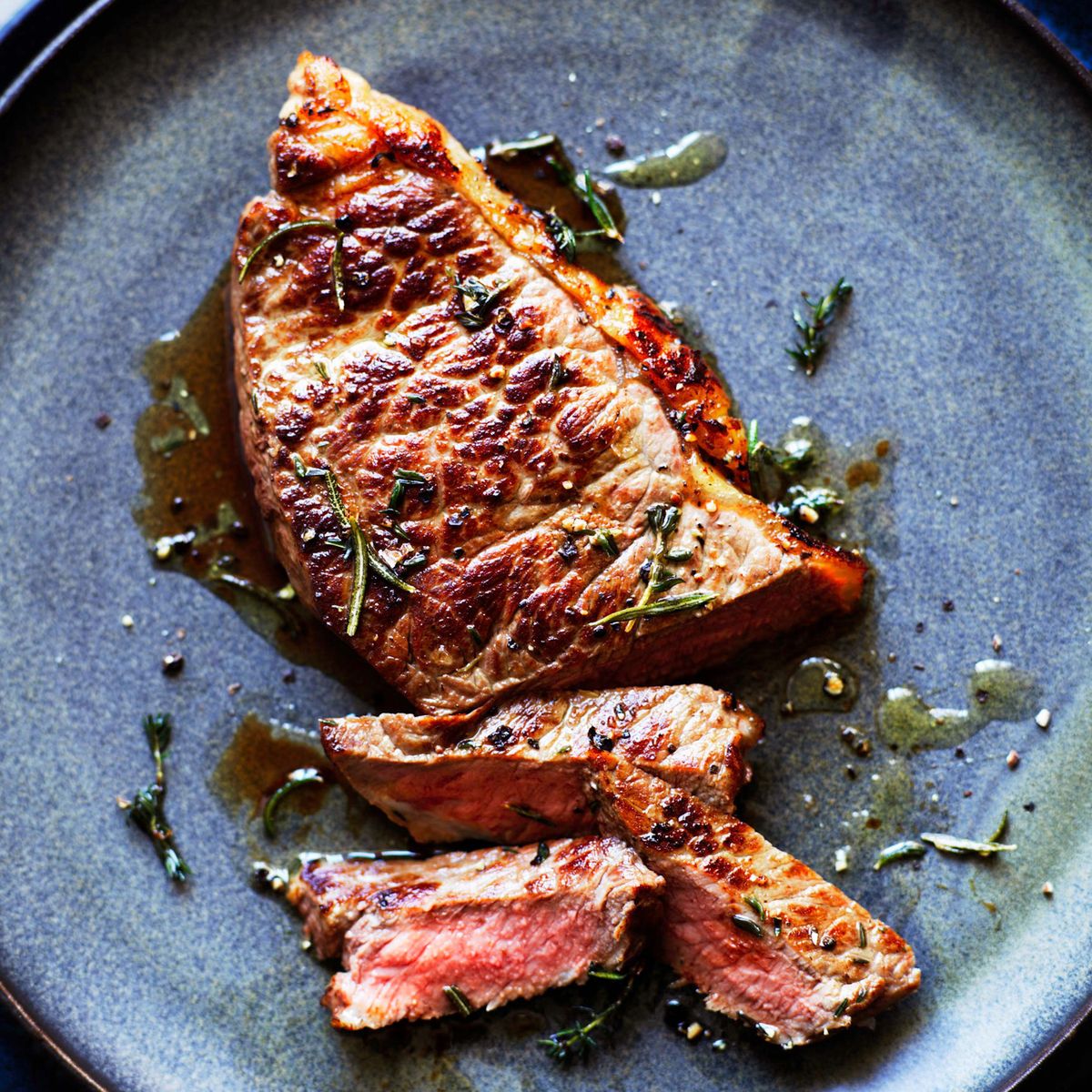 steak with herbs on a blue plate, how to cook steak in the oven