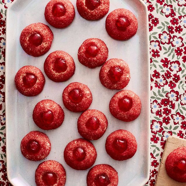 red cherry thumbprint cookies on white plate