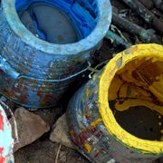 used, empty paint cans in blue red and yellow